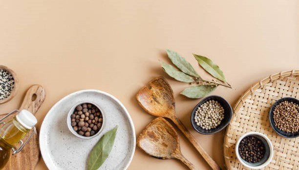 Hand-blended spice mixes in ceramic bowls with a mortar and pestle on a kitchen counter